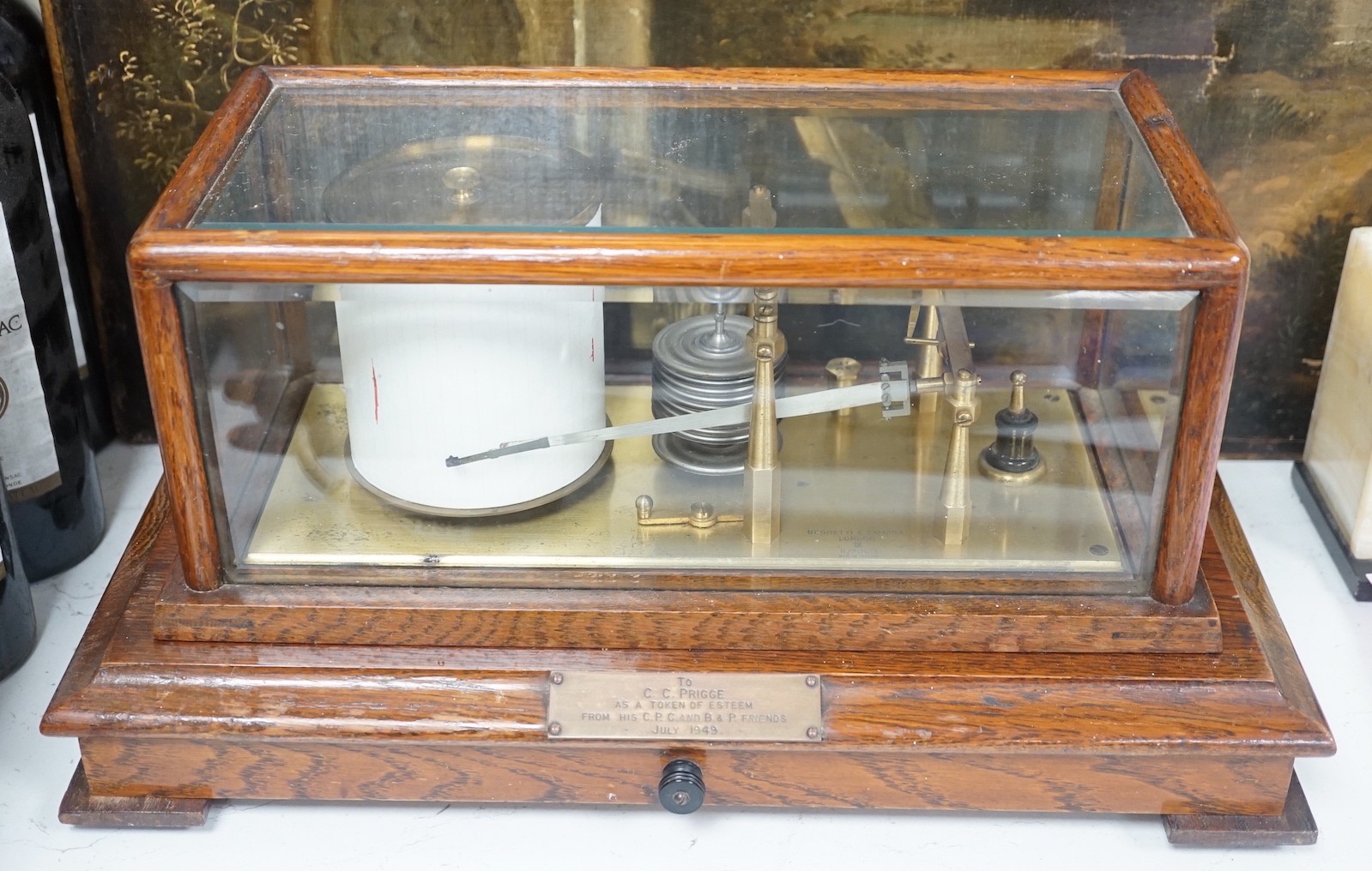 A Negretti and Zambra oak cased barograph number R/20613 with plaque reading ‘To C.C. Prigge as a token of esteem from his C.P.C. and B&P friends July 1949’